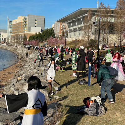 Cosplayers and photographers line the waterfront.