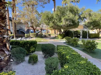 Walkways wrap around landscaping and trees.